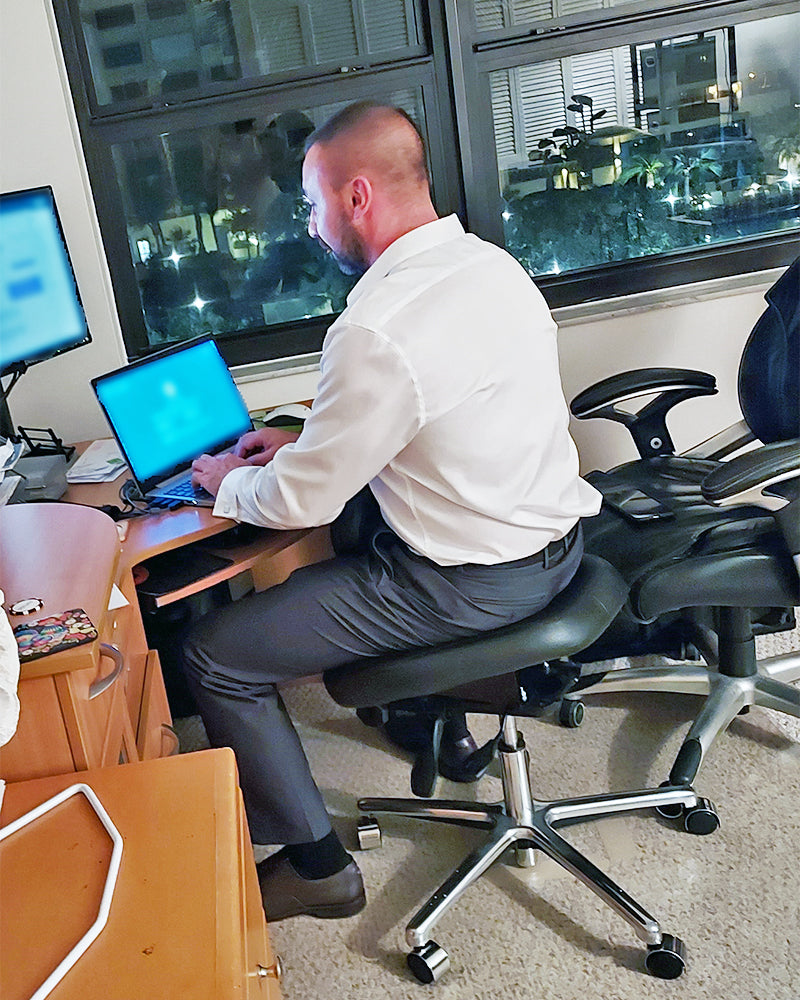 Man sitting in a NuChair conducting business