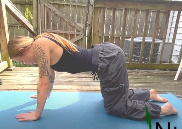 Woman performing Cat-Cow stretches